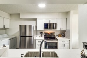 Dishwasher, coffee/tea maker, cookware/dishes/utensils, dining tables