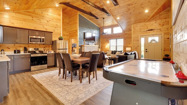 A spacious log cabin interior with a kitchen, dining area, and a pool table. - 1 Mi to Douglas Lake: Blissful Escape w/ Hot Tub! (Sevierville)