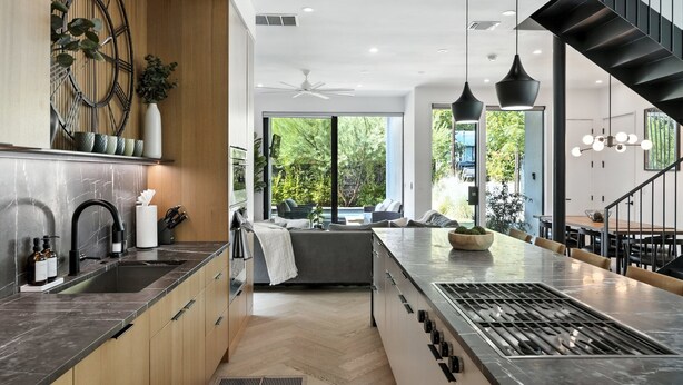 A modern kitchen with a large island, built-in appliances, and a view of the outdoors. - The Lunith Retreat, Luxury Stay w/ Pool & Spa (Austin)