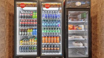 A vending machine with multiple beverage options including sodas, juices, and energy drinks.