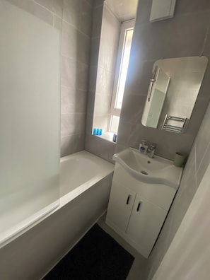 Shower, hair dryer, towels, toilet paper