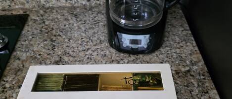A white box labeled "TEA" on a granite countertop.