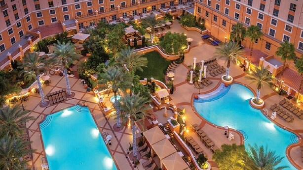 A hotel with multiple swimming pools, outdoor seating areas, and palm trees. - Sports fans, Luxurious 2-bed 2 Bath resort with pool, full kitchen washer/dryer (Las Vegas)