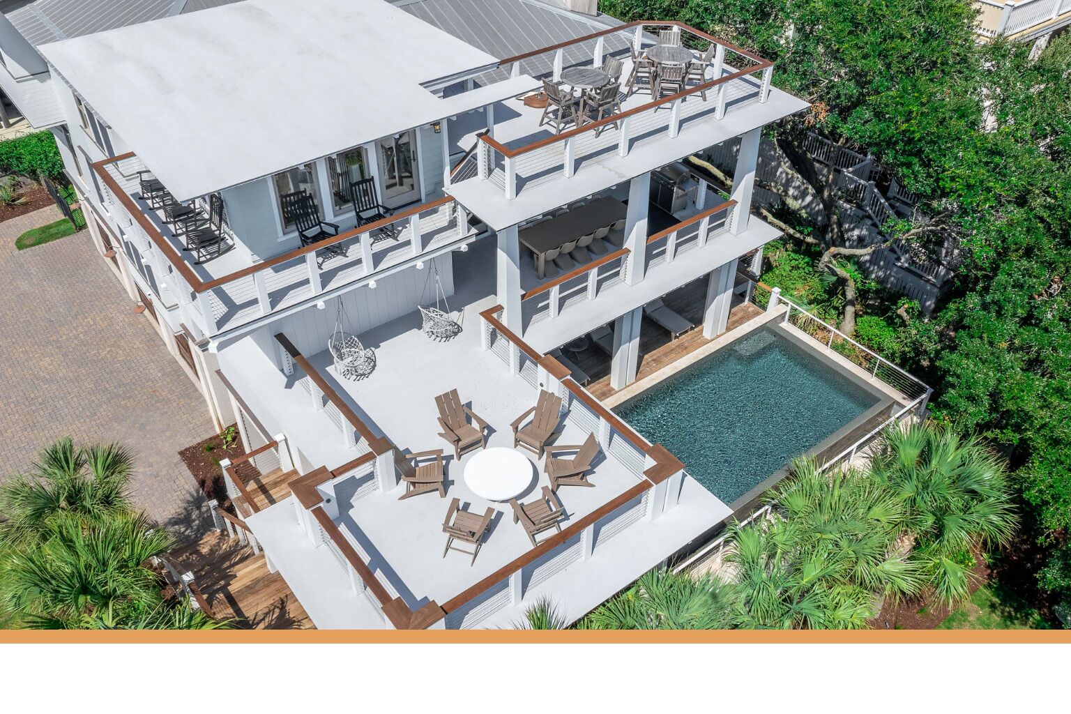 A multi-story building with a rooftop pool and outdoor seating areas.