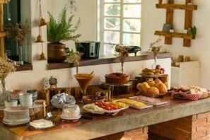A breakfast buffet with various food items and dishes. - Recanto Das Rosas Pousada & Spa (Braganca Paulista)