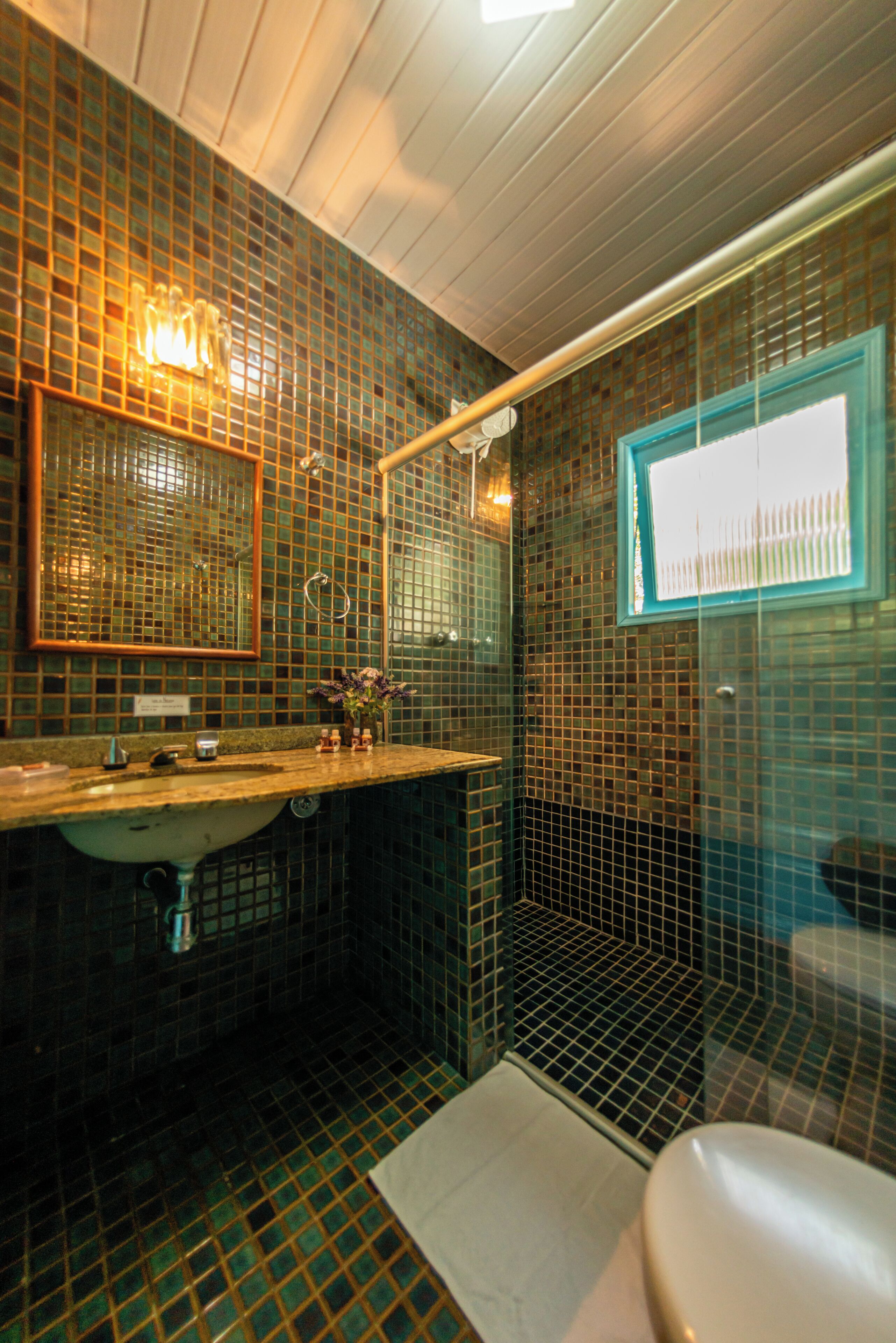 Un bagno con lavandino, specchio e water.