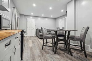 A modern kitchen with a microwave, cabinets, and a wooden countertop. - Quaint 1BR,1BA near the falls (Niagara Falls)