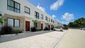 A modern multi-story residential building with a paved driveway and parked cars. - NEW villa with plunge pool, 3 mins to beach - Sorrento 10 (Lower Carlton)