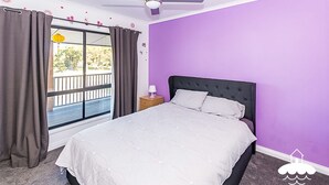 A bedroom with a bed, a nightstand, a window with curtains, and a view of the outside. - Fishermans Stay at Port Franklin (Port Franklin)
