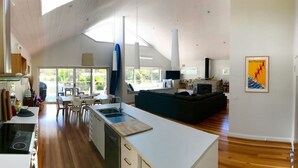 A spacious living area with a kitchen, dining area, and a fireplace.