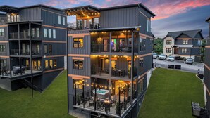 A multi-story building with balconies, outdoor seating, and a hot tub. - Sleeps 21 | Indoor Pool | Resort Waterpark | Views (Sevierville)