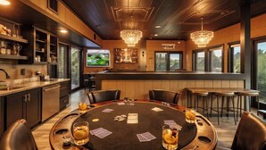 A casino-style room with a poker table, chairs, and a bar area. - Sleeps 21 | Indoor Pool | Resort Waterpark | Views (Sevierville)