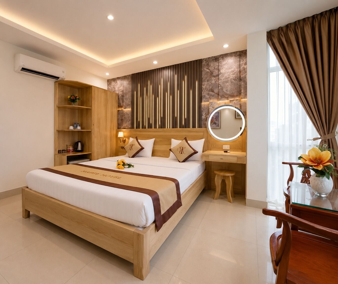 A hotel room with a wooden bed, a bedside table with a mirror, a small stool, and a desk with a vase of flowers.