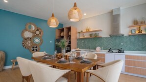 A modern kitchen with a herringbone backsplash, wooden cabinets, and a central island. - Villa Palma Blanca Canggu by Nagisa Bali (Kerobokan)