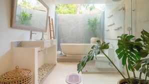 A modern bathroom with a bathtub, shower, and large mirror. - Villa Palma Blanca Canggu by Nagisa Bali (Kerobokan)