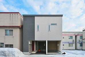 A modern building with a flat roof, large windows, and a covered entrance. - STAY IN ASAHIBASHI (Asahikawa)