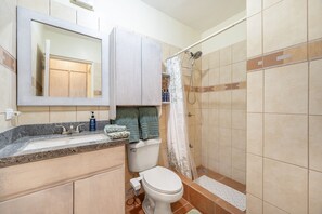 A bathroom with a sink, toilet, and shower. - Peaceful Condo, Pool View, Access to 7 common Pools, Gated, a minute drive beach (Playa Ocotal)
