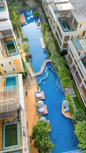 A multi-level hotel with a central swimming pool, multiple balconies, and lush greenery. - Luxury Residence Klong Muang Beach Krabi (Krabi)