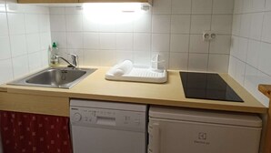 A kitchen with a dishwasher, a microwave, a sink, and a countertop with a soap dispenser. - Paradiski closed to the slopes and shop vallandry (LANDRY)
