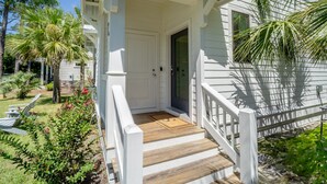 A white house with a wooden porch and a door. - Walk2Beach•Free Golf Cart•YOLO Bikes (Santa Rosa Beach)