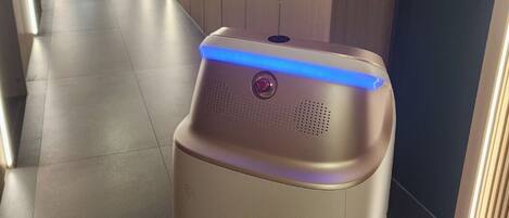 A hallway with a stationary air purifier in the center.