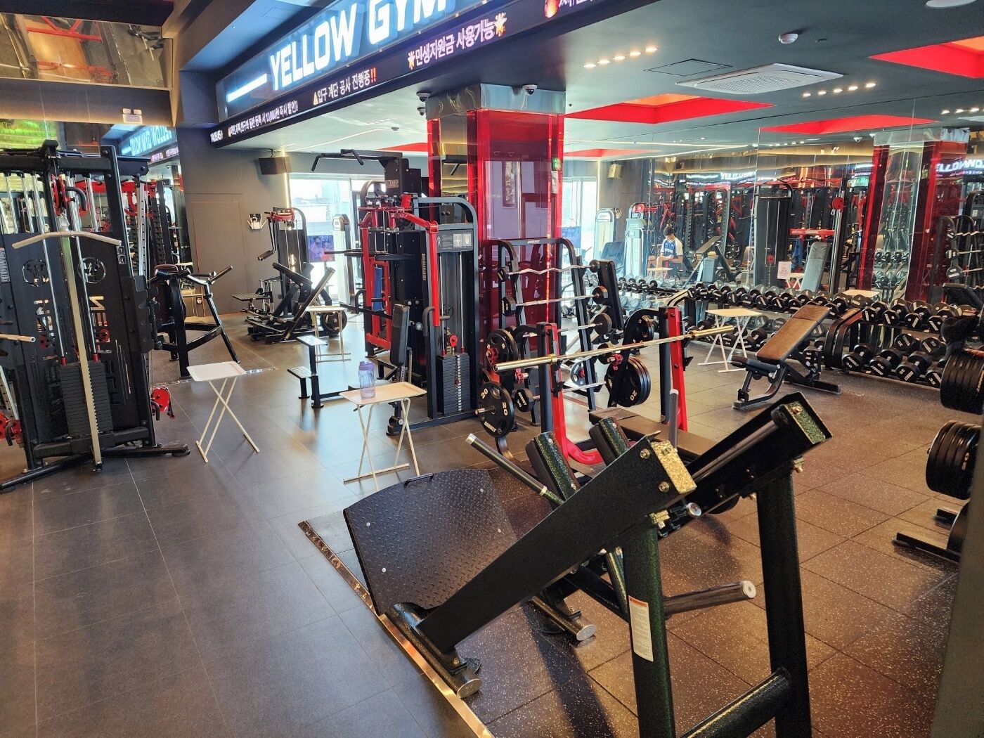 A gym with various exercise equipment, including weight machines and free weights.