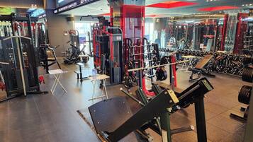 A gym with various exercise equipment, including weight machines and free weights.