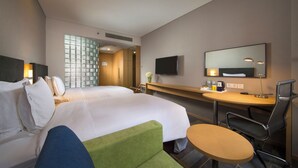A hotel room with a large bed, a desk, a chair, a TV, and a window with a view. - Huiyue Hotel  (Chengdu)