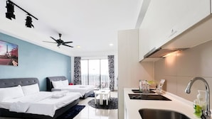 A modern hotel room with two beds, a kitchenette, and a balcony with a view.