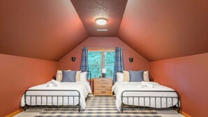 A bedroom with two beds, a window with curtains, a ceiling light, and a wooden dresser. - 6 Br Sleeps 20 I Sauna•Theater•Putt Putt•Hot Tub (Asheville)