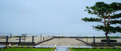 A pathway leading to a beach with a clear view of the ocean.