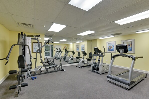 A gym with various exercise equipment, including treadmills, ellipticals, and weight machines. - Navarre Condo w/ Beach Access & Ocean Views! (Navarre)