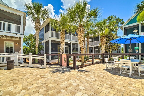 A courtyard with a brick floor, white fences, and palm trees. - Resort-style Port St Joe Escape ~ 3 Mi to Downtown (Port St. Joe)