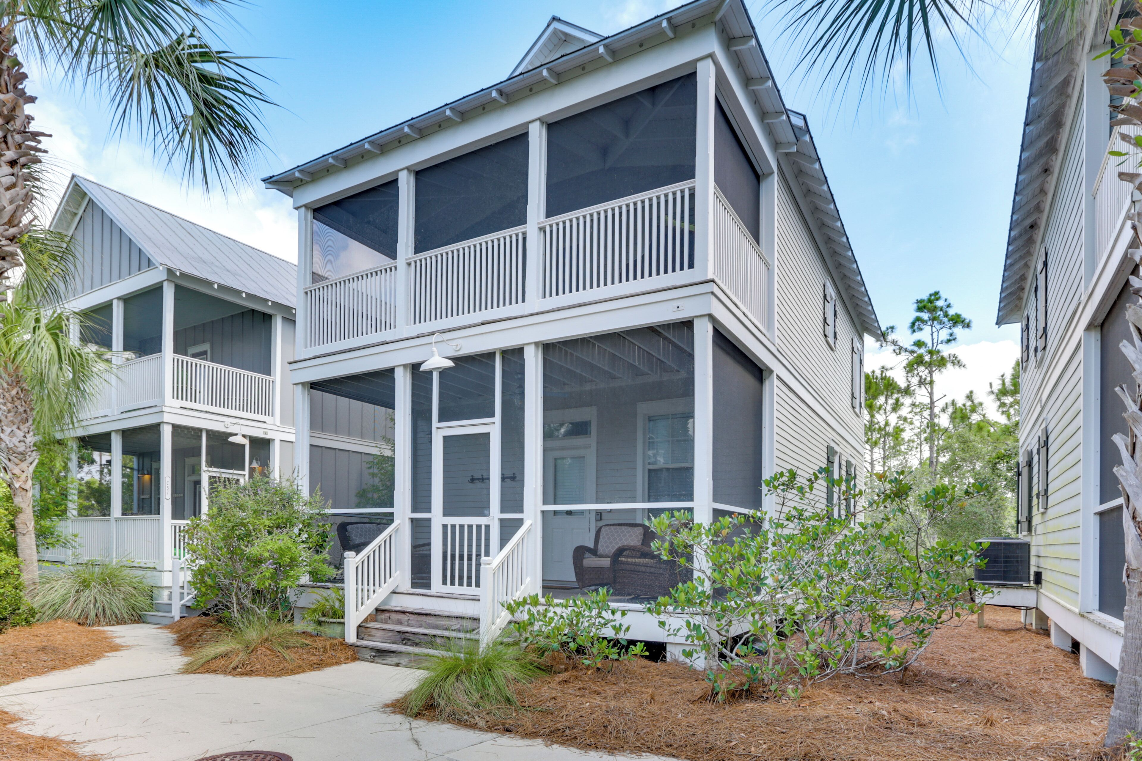 A two-story house with a balcony and a covered porch.