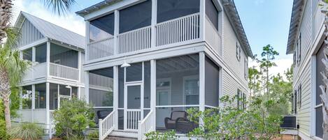 A two-story house with a balcony and a covered porch.