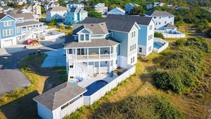 A coastal residential area with houses featuring balconies and a swimming pool.