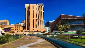 A modern building with a curved facade and a sign reading "ADELAIDE CONVENTION CENTRE". - Unwind Adelaide City Studio No 438 (Adelaide)