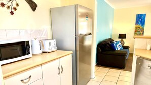 A compact kitchen with a microwave, toaster, and refrigerator. - Lakeside Getaway - 4BR Jetty Wi-fi Waterfront (Encounter Bay)