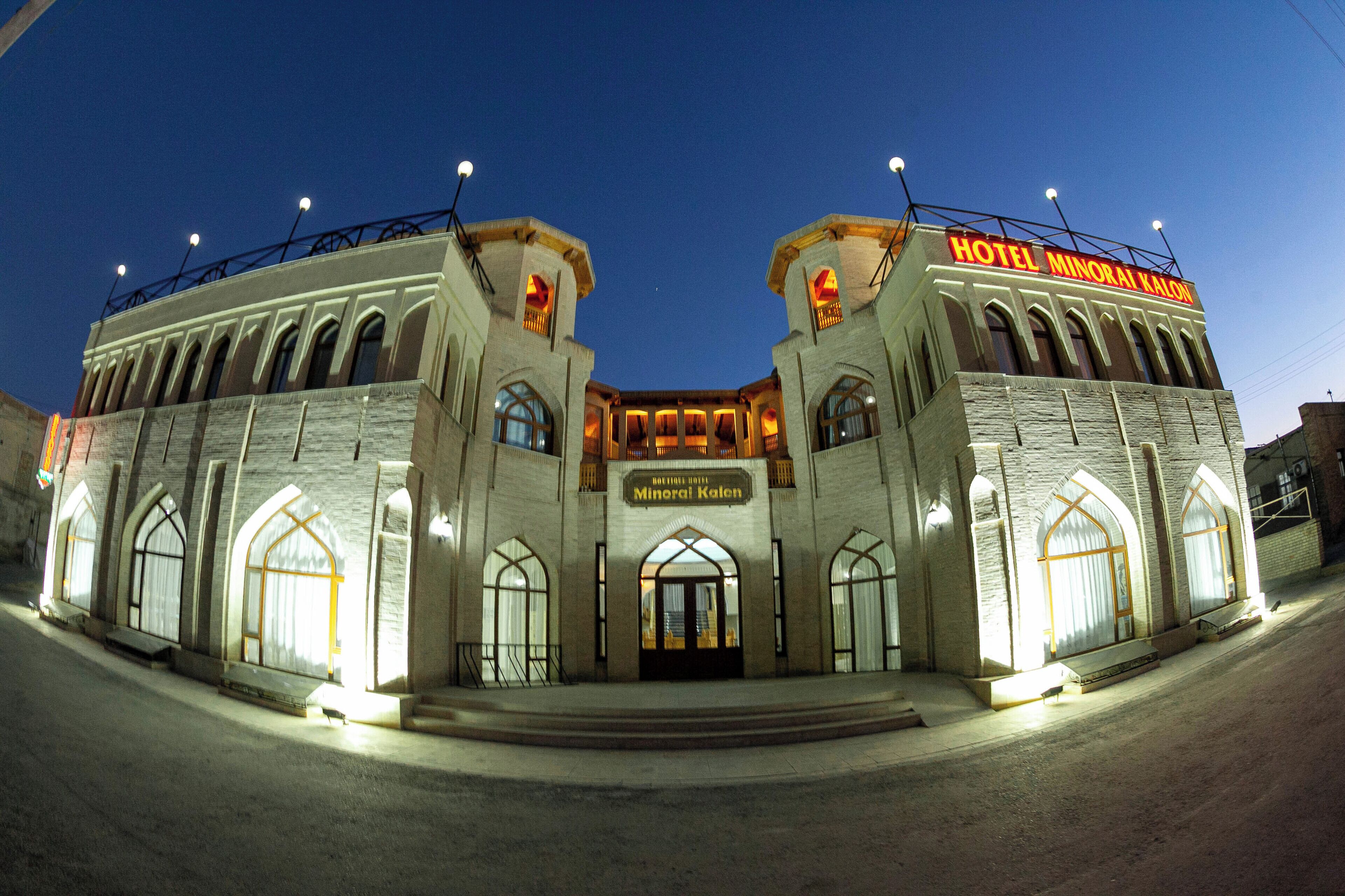 A large, historic building with arched windows and a prominent entrance.