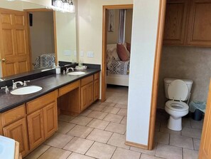 A bathroom with a sink, mirror, and toilet. - Del City 6 Bed 2.5 Bath-Sleeps 14!, The Gathering-Spacious 6 Bedroom (Del City)