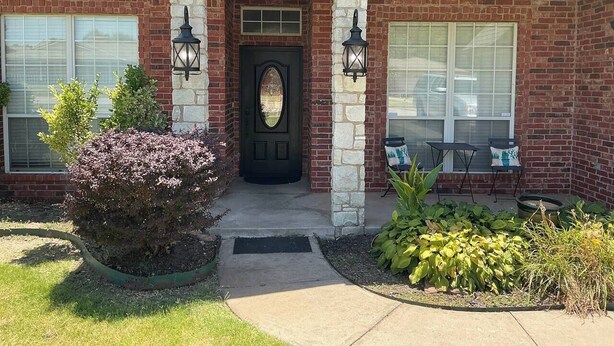 A house with a brick facade, a black front door, and two windows on either side. - Del City 6 Bed 2.5 Bath-Sleeps 14!, The Gathering-Spacious 6 Bedroom (Del City)