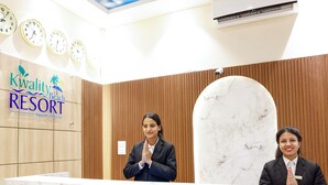 A reception desk at Kwality Beach Resort with wooden paneling and marble accents. - Kwality Beach Resort (Purano Jhangajholi)