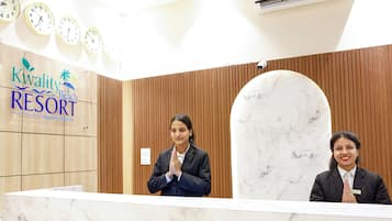 Een receptiebalie bij Kwality Beach Resort, met houten lambrisering en marmeren accenten.
