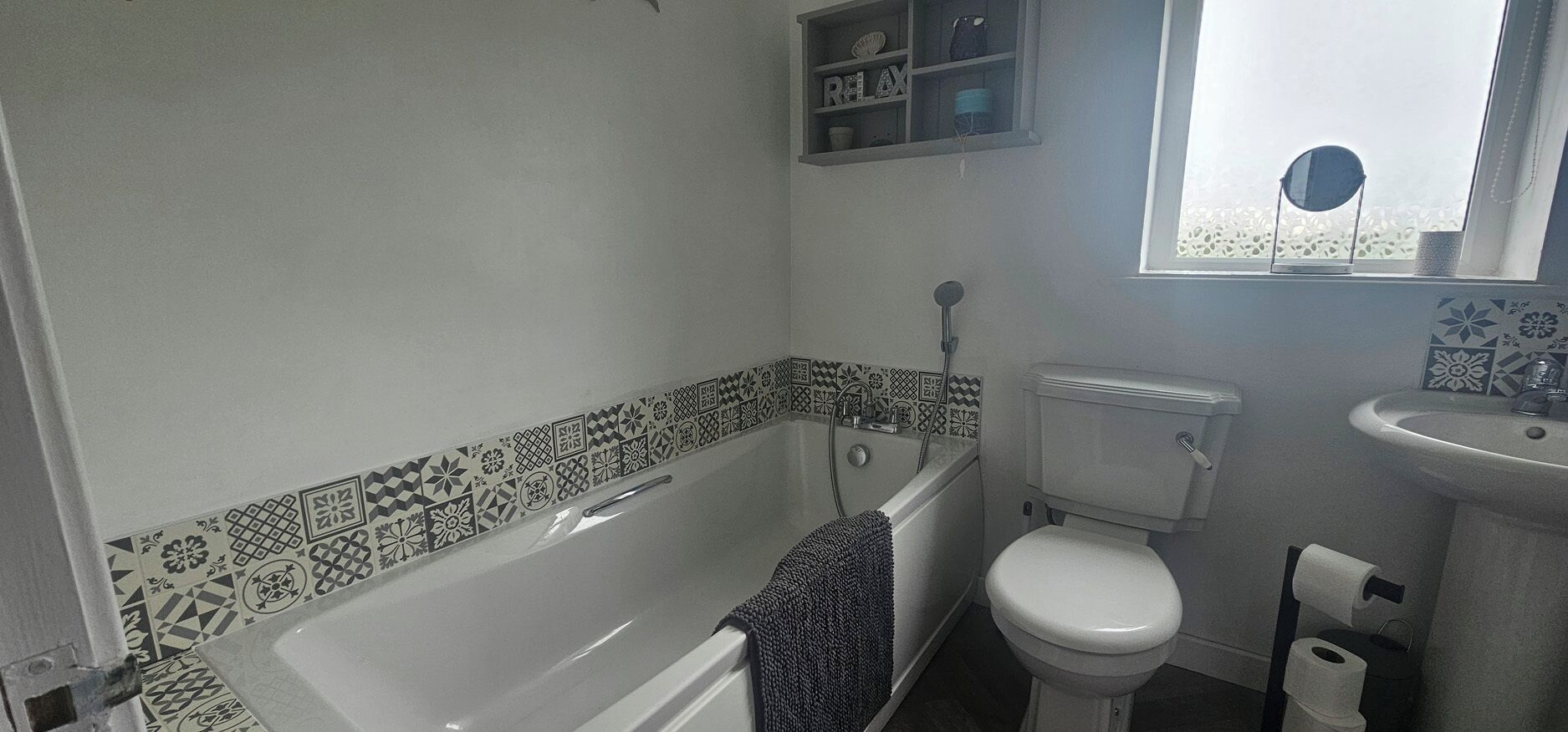 A bathroom with a bathtub, toilet, and sink.