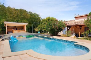 A swimming pool with a diving board, surrounded by trees and a covered patio area. - Studio with Shared Pool, Wi-Fi, and Air Conditioning (Montayral)