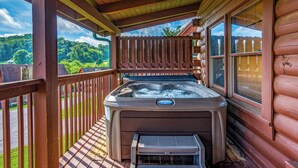A hot tub on a wooden deck with a view of a forest. - Free Dollywood Tix/HotTub/Dog Friendly/A+ Location (Sevierville)