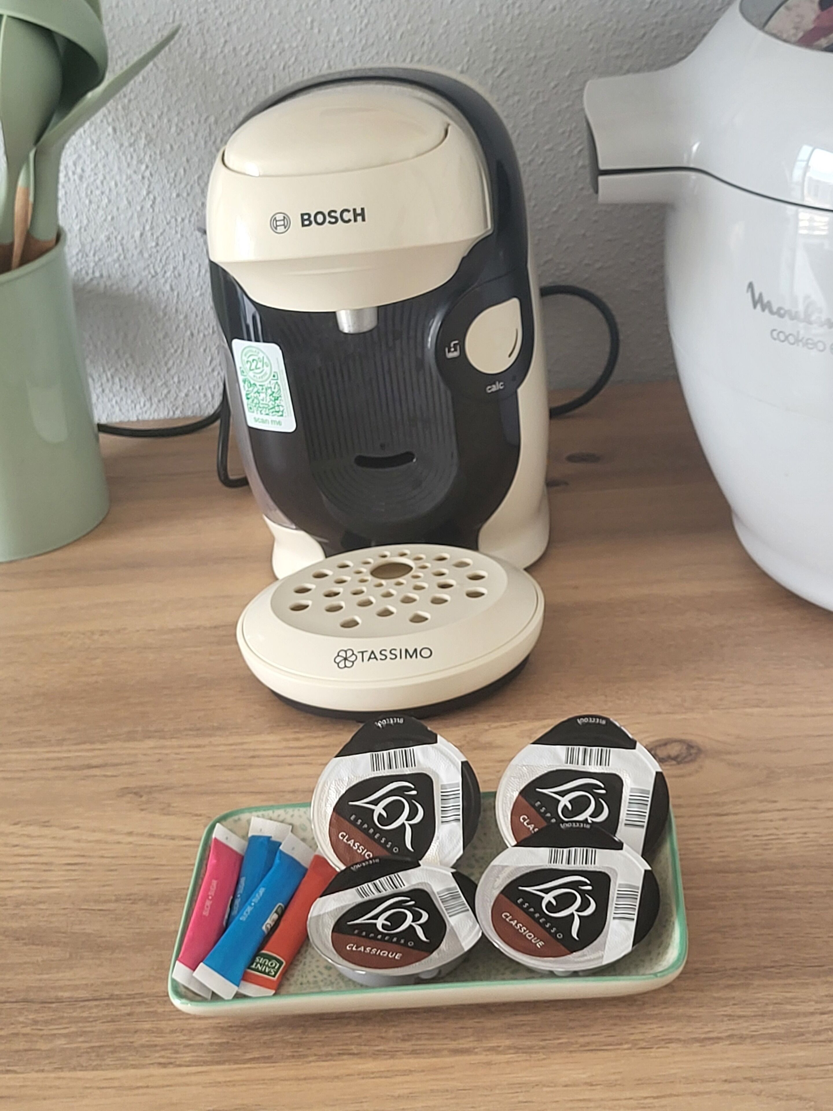 A coffee machine with a TASSIMO coffee pod holder in front of it.
