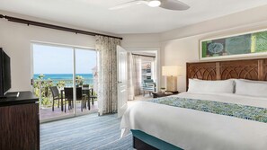 A hotel room with a large bed, a balcony with a view of the ocean, a dining area with chairs, and a television. - 2 Bedroom Ocean View Stay- Blissful Aruba Vacation at Marriott's Aruba Surf Club (Noord)