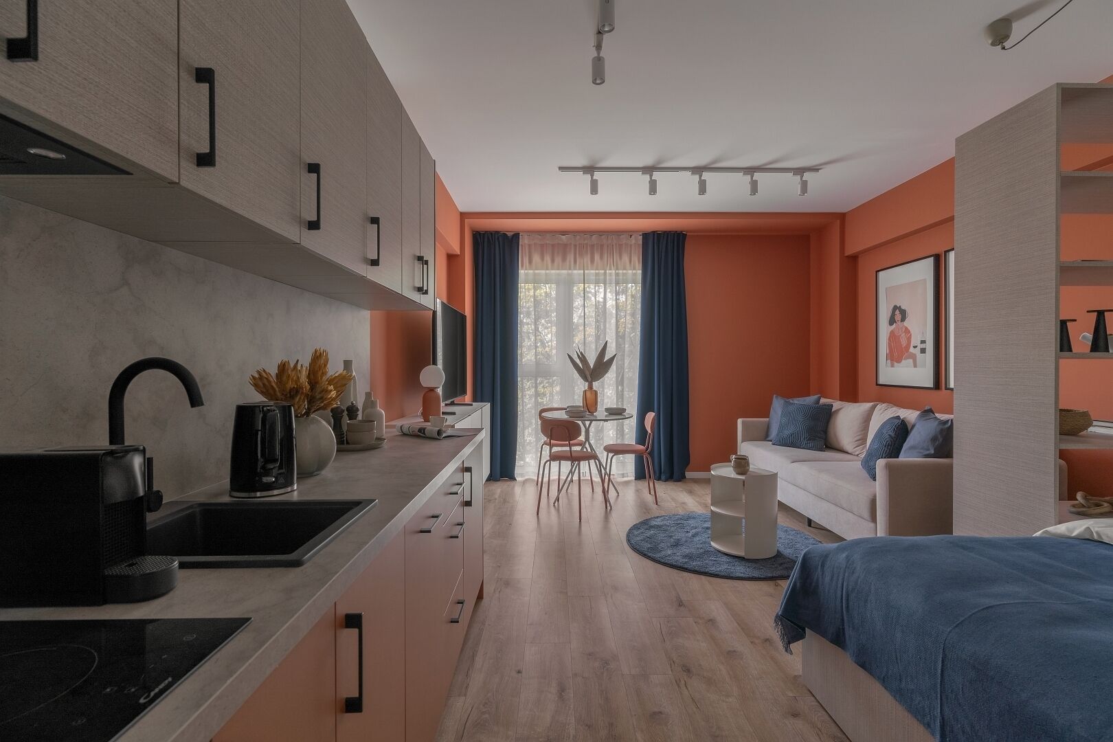 A modern apartment with a kitchen, dining area, and living room.