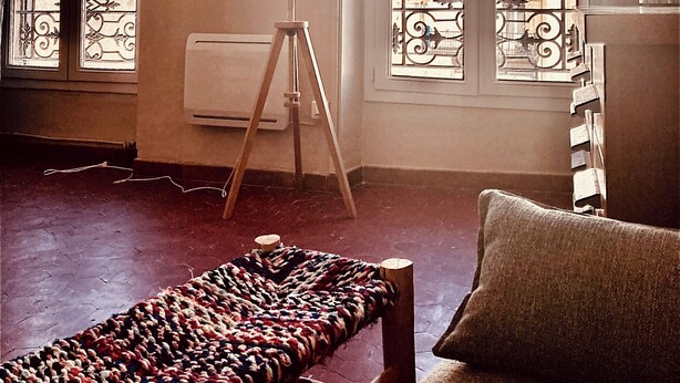 A room with a bed, a floor lamp, and a view of buildings through large windows. - Bright, quiet apartment near Panier, Vieux-Port, Joliette (Marseille)